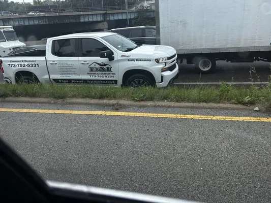 D&M Roofing & Tuckpointing Logo