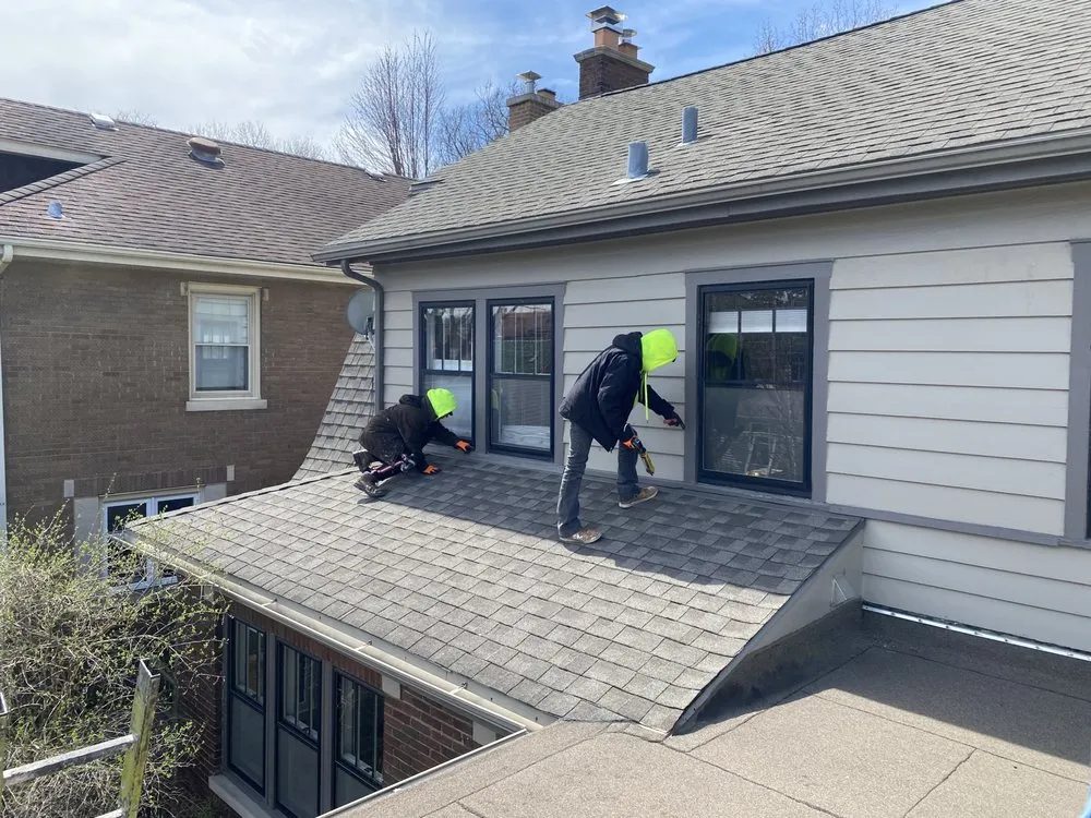 Slide of Economy Roofing Team