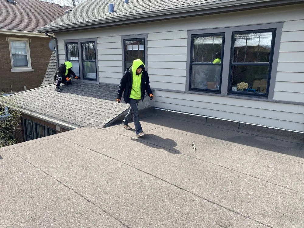 Slide of Economy Roofing Team