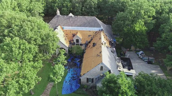 Mac's Roofing Construction & Restoration Logo