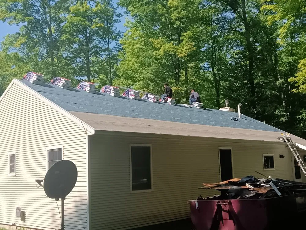 Professional flat roof repair for residential properties across Williamsburg, MI - Outdoor Living & Exteriors