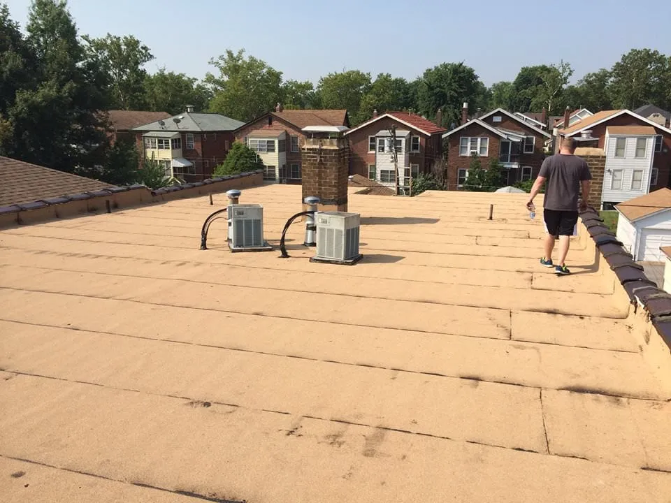 Expert flat roof repair after storm damage in St. Louis, MO by The Happy Roof Company