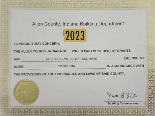 TM Roofing and Construction Logo