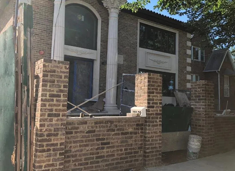 Licensed storm damage roof repair after storm damage in South Richmond Hill, NY by Tri-Force Construction