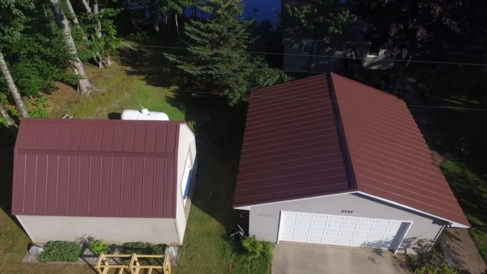 Local storm damage roof repair in Williamsburg, MI by Up North Exteriors